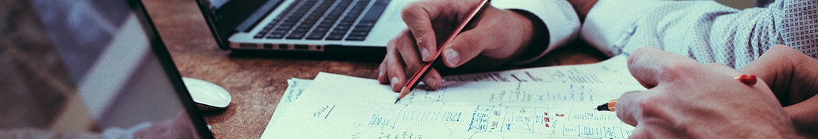 The hands of two people working on notes